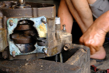 The motorcycle carburetor is waiting for maintenance and repair and the engine and mechanic check the engine.	