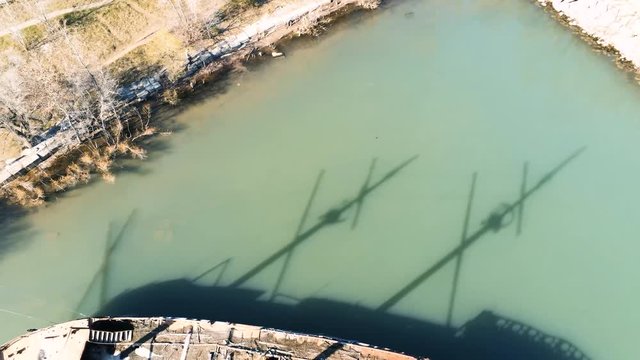 Overhead rusty sunken shipwreck with geese nesting