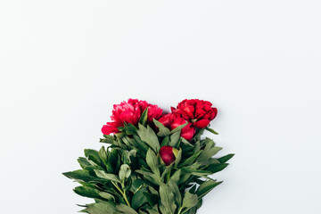 Simple freshly cut bunch of pink peony flowers with green leaves