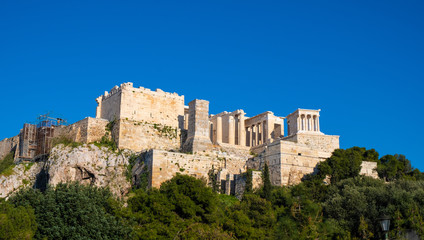 Fototapeta premium Panoramic view of Acropolis of Athens with Propylaea monumental gateway and Nike Athena temple seen from Aeropagus rock in Athens, Greece