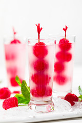 Raspberry Tequila Shots Lemonade Cocktail with Fresh Raspberry on White Background. Selective focus.