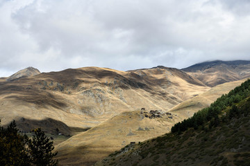 Sunlit village at the top of a mountain