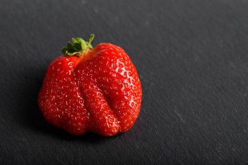 Fresh organic strawberries isolated on a black background. Delivery of natural products. Packaging made from organic strawberries.