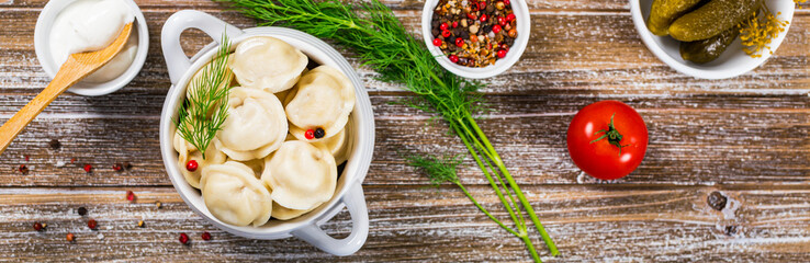 Meat Dumplings, Russian Pelmeni Wooden Background. Panoramic image. Selective focus.