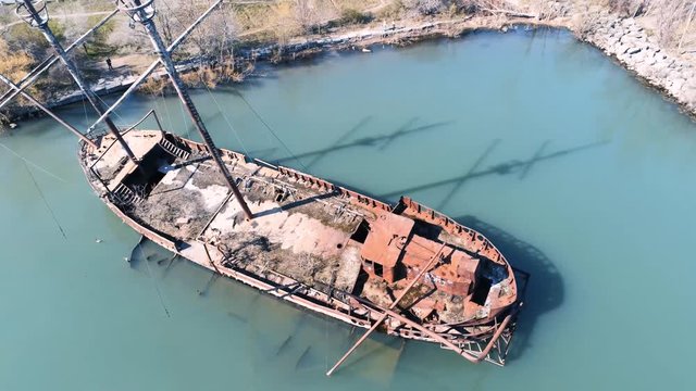 Aerial view of rusty shipwreck sunken boat