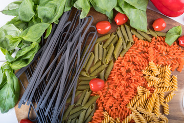 Assortment of different types of gluten-free penne pasta from chickpeas, red lentils, peas