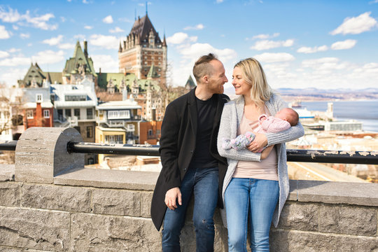 A Couple with baby in front of Chateau Frontenac at Quebec city Canada