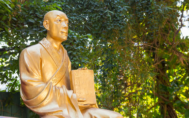 Beautiful buddha statue unique medium close shot. Golden sculpture representing an old...