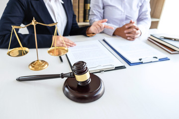 Professional Female lawyer discussing negotiation legal case with client meeting with document...