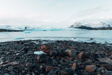 Breathtaking glacier in Iceland with black rock and large ice sheets, melting ice due to climate change