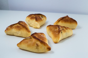 Brazilian snack. Meat Esfiha on white background.
