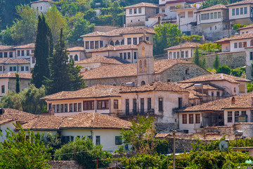 Fototapeta premium Albania - Berat - The historical white houses under red tile with church and bell tower in UNESCO world heritage site