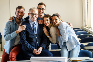 Group portrait of senior professor with his students.	
