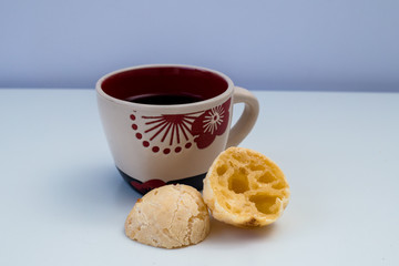 Brazilian snack cheese bread and cup of coffee on with background