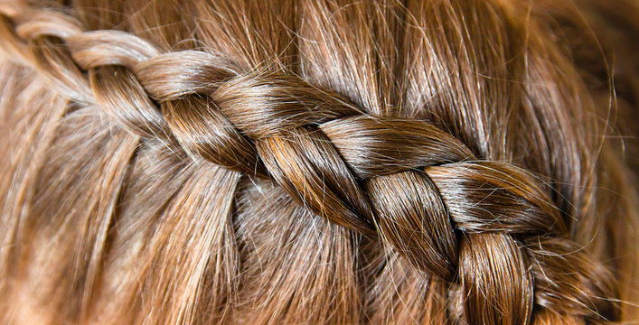 French Braid, On The Contrary, Is Braided On Dark Long Shiny Healthy Hair. Hairstyle For Long Hair.