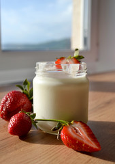 Yogurt with strawberries  on a wooden table. Tasty and healthy breakfast