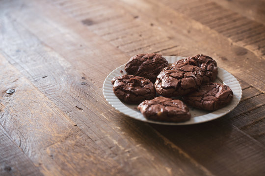 Dark chocolate cookies biscuits on a wooden table