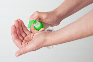 The hand holds a tool for cleaning windows, glasses and mirrors. Selective focus
