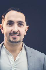 Obraz premium Funny handsom businessman in trendy taxedo looking at the camera with playful, comical face expression.
