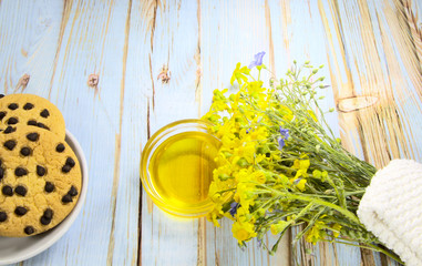 Yellow wildflowers and flower honey on the table. Medicinal plant, homeopathy.