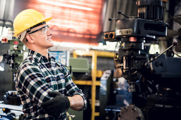 Fototapeta na wymiar Portrait images of Caucasian male engineer are standing and smiling at workplace Which is and industrial factory, with blur soft machinery background, to people and worker concept.