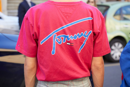Man with pink Tommy shirt with blue writing on September 23, 2018 in Milan, Italy