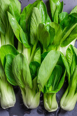 Fototapeta premium Top view green bok choy ready to cook on. chopping stone.