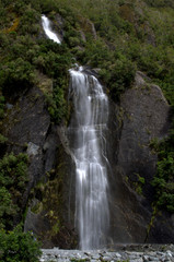 Fototapeta na wymiar Waterfall next to Franz Josef Glacier in West Coast of South Island, New Zealand