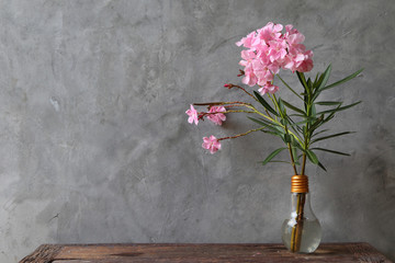 Pink bouquet in a vase placed on a wooden table
