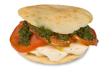 Delicious arepa stuffed with white cheese and tomatos