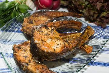 Freshly grilled fish on kitchen table. closeup, top view.