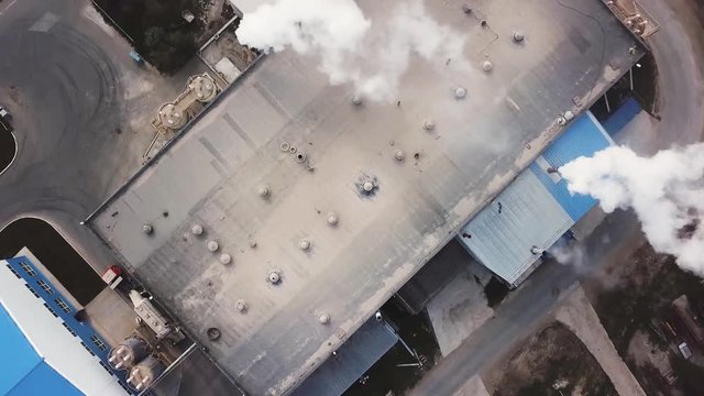Plant for the production of cement, clinker and gypsum. Stock footage. Aerial view of concrete mixing factory, industrial zone on a sunny summer day.