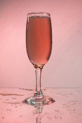 Glasses with red wine on a background reflection, pink background