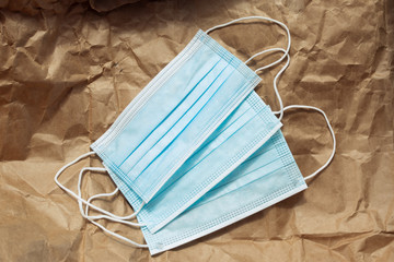 Blue antibacterial medical masks on craft paper. Infections and viruses protection