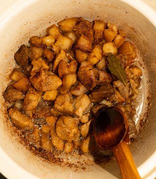 Delicious unhealthy fried pork greaves in the pan traditional Romanian Christmas dish. Jumari