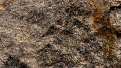 Grey-Brown granite. Granite rocks. Rusted background. Colorful Rock background