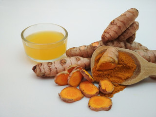 turmeric oil in glass container, root and turmeric powder, white background
