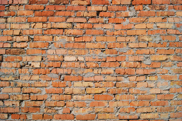 Old brick wall, old texture of red stone blocks closeup.