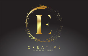 E golden letter logo with golden sparkling rings and dust glitter on a black background. Luxury decorative shiny vector illustration.