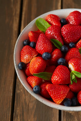 fresh strawberries on a dark wooden surface