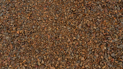 Small granite gravel stones. Gravel texture. Small size. Brown Stones