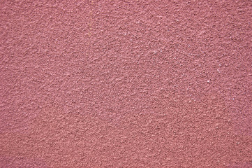 Pink horizontal wall covered with plaster texture.
