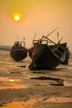 Indian boat resting in sea side during sunset
