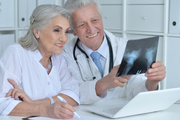 Portrait of professional doctors working in cabinet