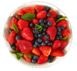 strawberries with mint leafs on granite surface