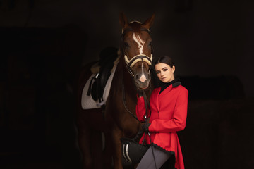Fototapeta na wymiar Portrait Jockey woman rider with brown horse, concept advertising equestrian club school