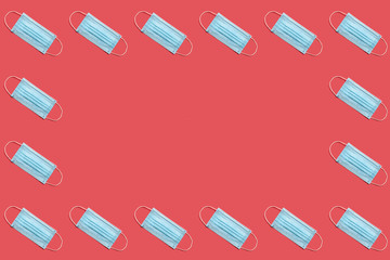 COVID-19 disposable surgical face mask on red background. Protection against coronavirus. Healthcare and medical concept. Seamless medical pattern with copyspace
