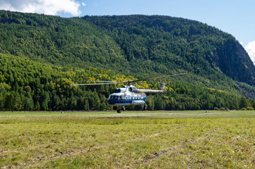 takeoff and landing helicopter in the mountains