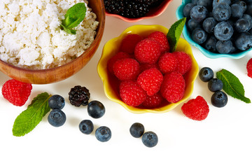 fresh cottage cheese and berries isolated on white