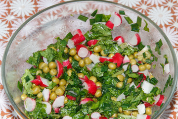homemade spring salad of red radish, green peas and leek 